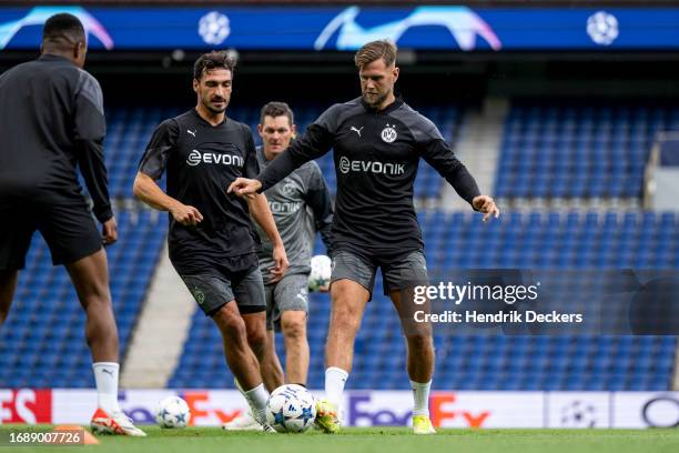 Mats Hummels and Niclas Fuellkrug of Borussia Dortmund at training ahead of their UEFA Champions League group match against Paris Saint-Germain at...