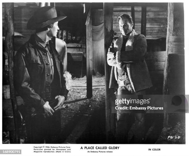 Pierre Brice and Lex Barker meet up in a barn in a scene from the film 'A Place Called Glory', 1965.