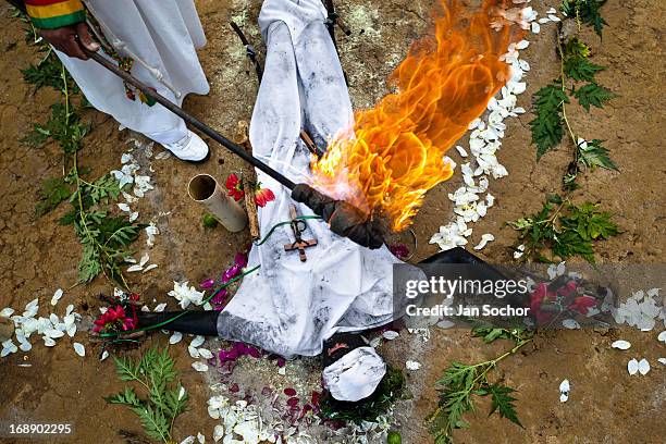 Hermes Cifuentes, a Colombian spiritual healer, performs a ritual of exorcism on Diana R., who claims to be possessed by spirits, on 28 May 2012 in...