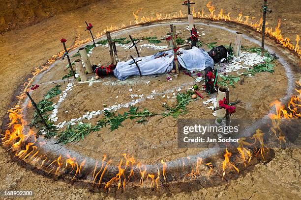 Diana R., who claims to be possessed by spirits, lies in a ring of fire during a ritual of exorcism performed by Hermes Cifuentes on 28 May 2012 in...