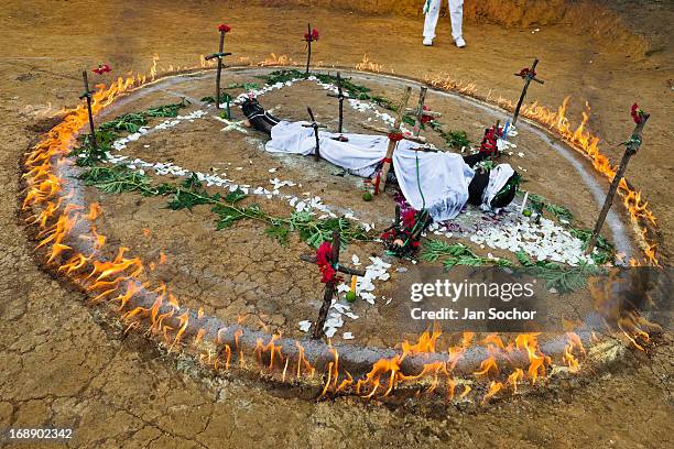 Diana R., who claims to be possessed by spirits, lies in a ring of fire during a ritual of exorcism performed by Hermes Cifuentes on 28 May 2012 in...