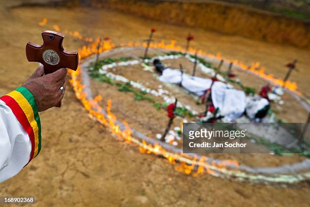 Hermes Cifuentes, a Colombian spiritual healer, helds a crucifix in his hand during a ritual of exorcism on 28 May 2012 in La Cumbre, Colombia....