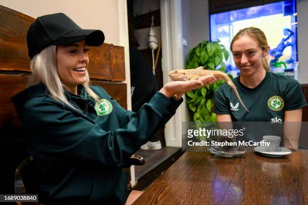 Budapest , Hungary - 25 September 2023; Republic of Ireland's Denise O'Sullivan and Megan Connolly, right, and a bearded dragon at Zoo Café in...