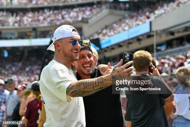 Former Aggie quarterback and Heisman Trophy winner, Johnny Manziel takes a selfie on the Aggie sideline during the football game between the Auburn...