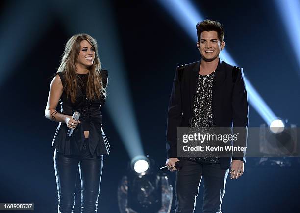 Singers Angie Miller and Adam Lambert speak onstage during Fox's "American Idol 2013" Finale Results Show at Nokia Theatre L.A. Live on May 16, 2013...