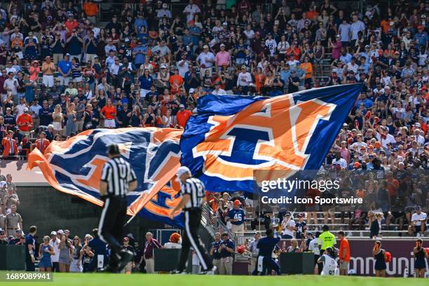 Auburn flag bearers rev up the Tiger crowd in the seats adjacent to the the corner of the endzone during the football game between the Auburn Tigers...