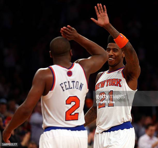Iman Shumpert of the New York Knicks celebrates with teammate Raymond Felton after defeating the Indiana Pacers in Game Five of the Eastern...