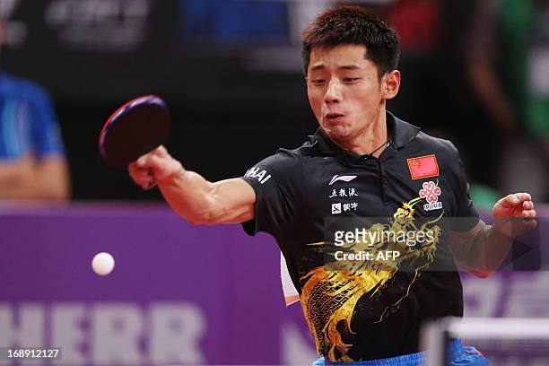 China's Jike Zhang plays against Brasil's Gustavo Tsuboion May 16, 2013 in Paris, during the second round of the Men's Singles of the World Table...
