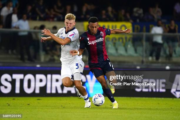 Josh Doig of Hellas Verona battles for the ball with Dan Ndoye of Bologna during the Serie A TIM match between Hellas Verona FC and Bologna FC at...