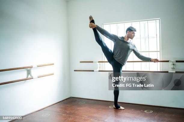 young man stretching at the dance studio - making art stock pictures, royalty-free photos & images