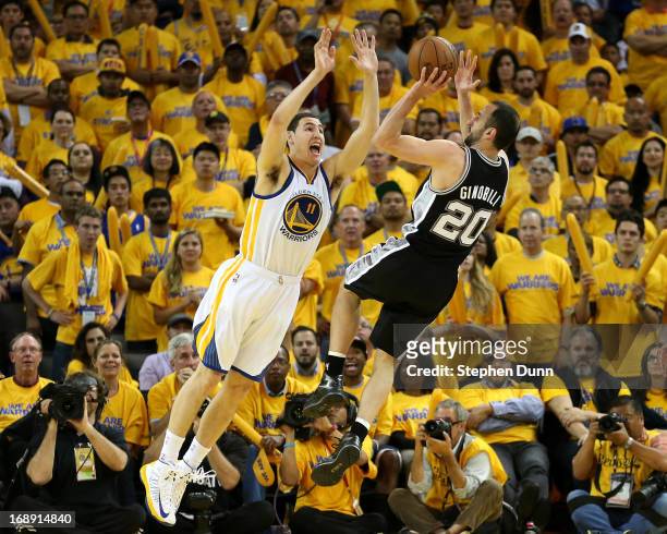 Manu Ginobili of the San Antonio Spurs shoots over Klay Thompson of the Golden State Warriors in Game Six of the Western Conference Semifinals during...