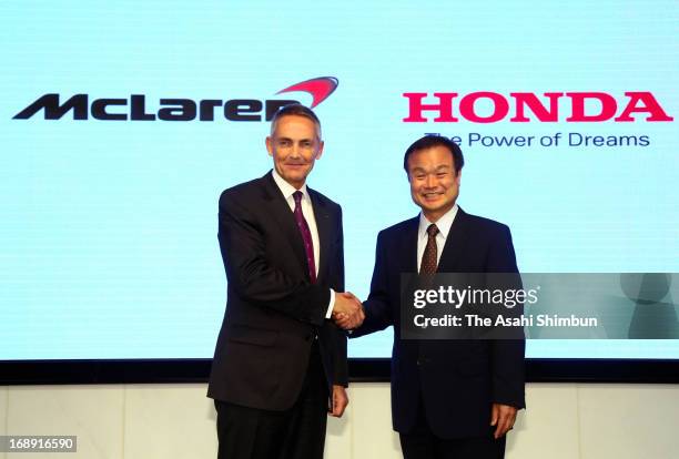 McLaren Group CEO Martin Whitmarsh and Honda Motor Co President Takanobu Ito shake hands during a press conference at Honda's headquarters on May 16,...