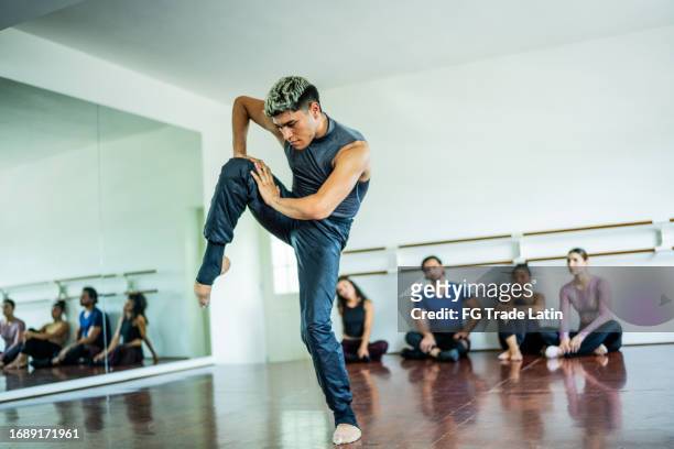 young man dancing at dance studio - jazz dancing stock pictures, royalty-free photos & images