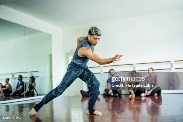 young man dancing at dance studio - jazz dancing stock pictures, royalty-free photos & images
