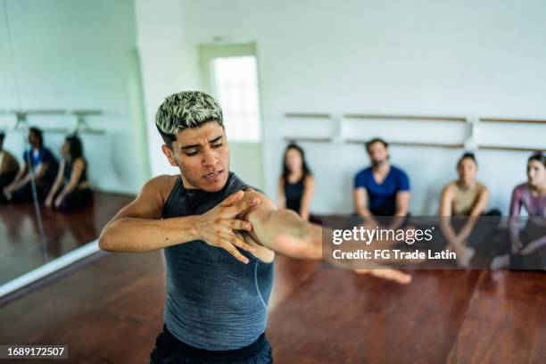 young man dancing at dance studio - modern dance class stock pictures, royalty-free photos & images