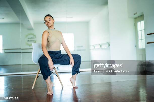 portrait of a young woman dancing at the dance studio - jazz dancing stock pictures, royalty-free photos & images