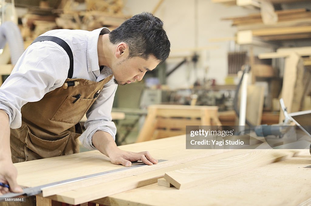 Man handcrafting furniture in workshop