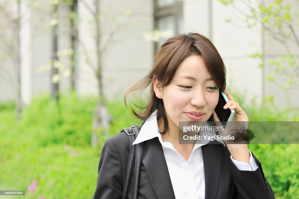 Business woman is using a smartphone