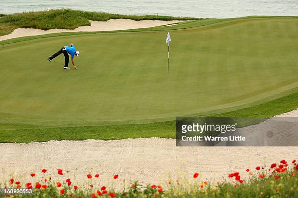 Brett Rumford of Australia marks his ball during the morning matches on day two of the Volvo World Match Play Championship at Thracian Cliffs Golf &...
