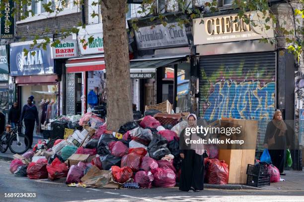 Refuse piled up in Bethnal Green during four weeks of strike action by waste service workers in Tower Hamlets on 25th September 2023 in East London,...