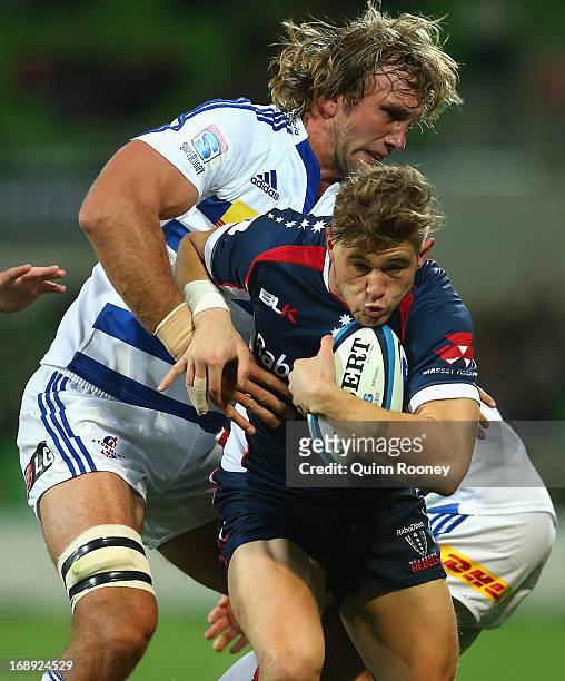 Jason Woodward of the Rebels is tackled by Andries Bekker of the Stormers during the round 14 Super Rugby match between the Rebels and the Stormers...