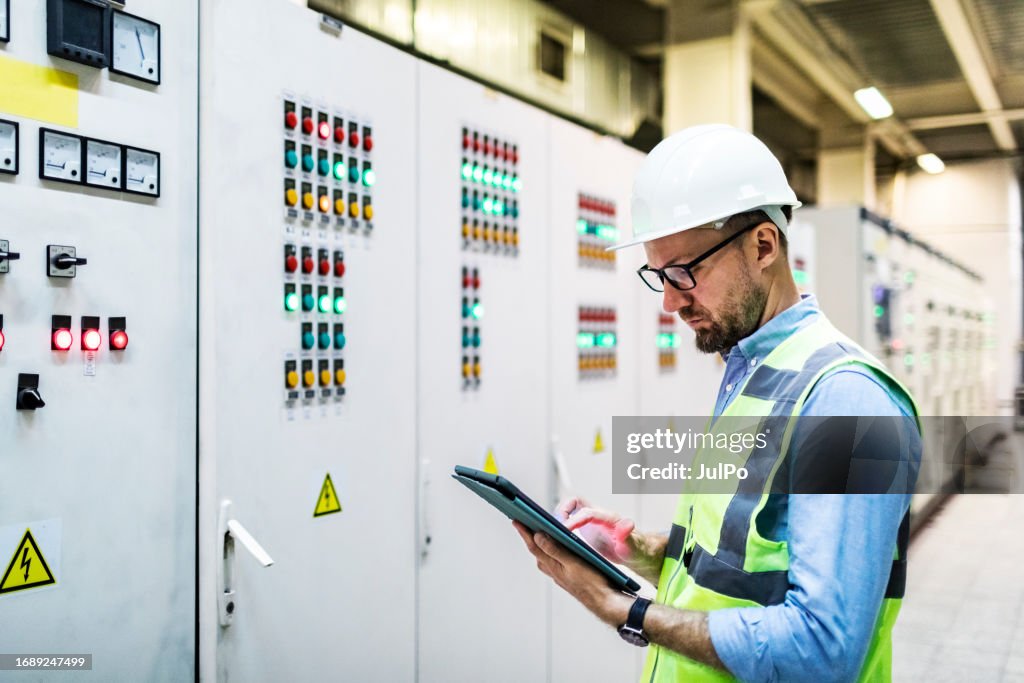 Control Protection Engineer Electrical Engineer Checking Power At Control Room Using Digital Tablet ...