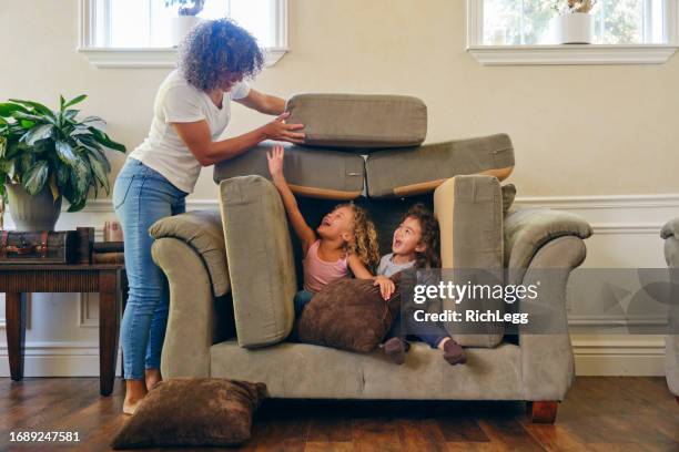 children playing in a home living room on a play date - play date stock pictures, royalty-free photos & images