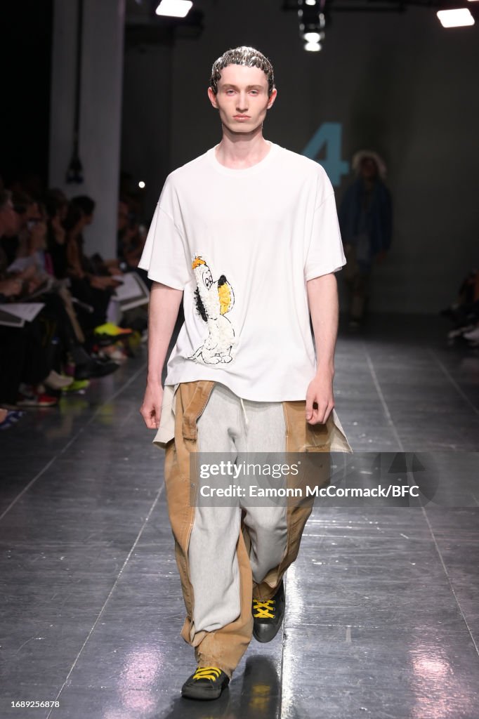 A model walks the runway at the University of Westminster MA Menswear ...