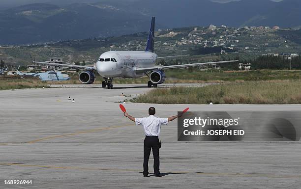 SyrianAir passenger plane taxis at Latakia airport on Syria's northwestern Mediterranean coast on May 15, 2013. International sanctions have piled up...