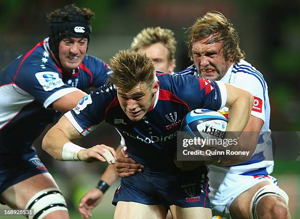 Jason Woodward of the Rebels is tackled by Andries Bekker of the Stormers during the round 14 Super Rugby match between the Rebels and the Stormers...