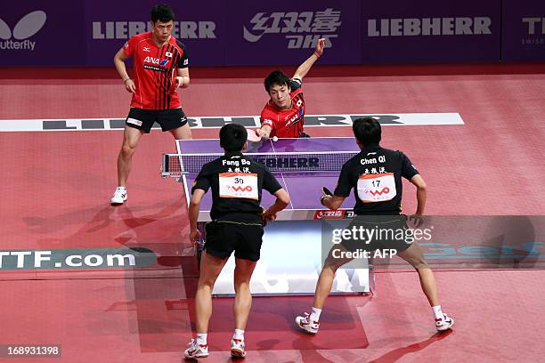 Japan's Kenji Matsudaira and Kazuhiro Chan compete against China's Qi Chen and Bo Fang on May 17, 2013 in Paris, during the quaterfinal of the Men's...
