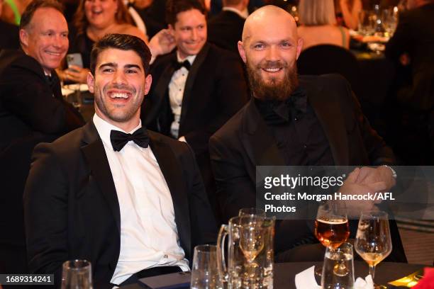 Christian Petracca and Max Gawn of the Demons react during the 2023 Brownlow Medal at Crown Palladium on September 25, 2023 in Melbourne, Australia.