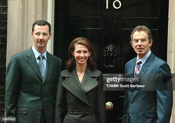 British Prime Minister Tony Blair greets Syrian President Bashar al-Assad and his wife Asma al-Assad as they arrive December 16, 2002 in London....