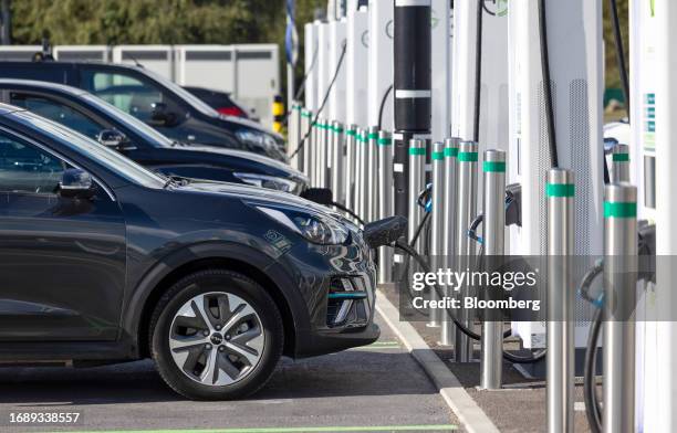 Electric vehicles plugged in at a charging hub in Thurrock, UK, on Friday, Sept. 22, 2023. UK Prime Minister Rishi Sunak said in a speech that he...