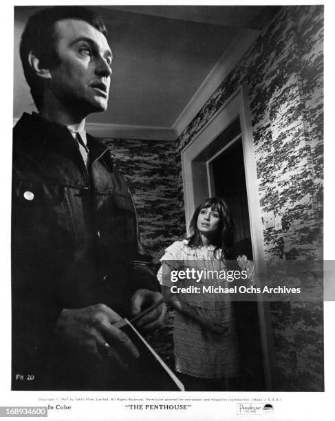 Suzy Kendall stands in the doorway looking at Tony Beckley in a scene from the film 'The Penthouse', 1967.