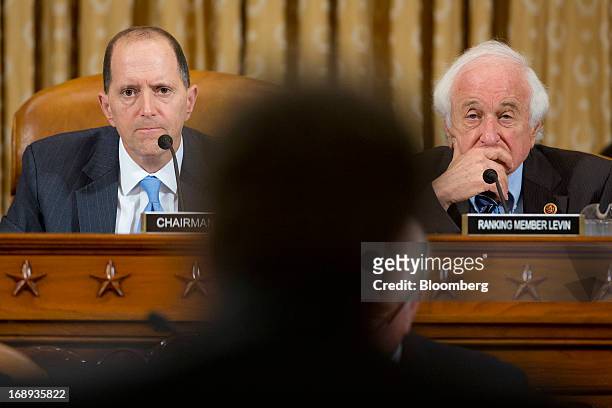 Representative Dave Camp, chairman of the House Ways and Means Committee, left, and Representative Sander Levin, a Democrat from Michigan, listen to...