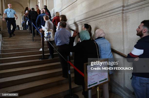 People arrive for the trial of the Magnanville attacks at the Paris courthouse on September 25, 2023. Mohamed Lamine Aberouz is accused of complicity...