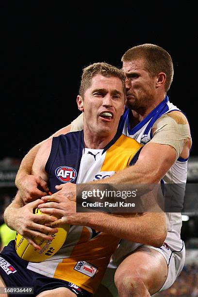 Leigh Adams of the Kangaroos tackles Adam Selwood of the Eagles during the round eight AFL match between the West Coast Eagles and the North...
