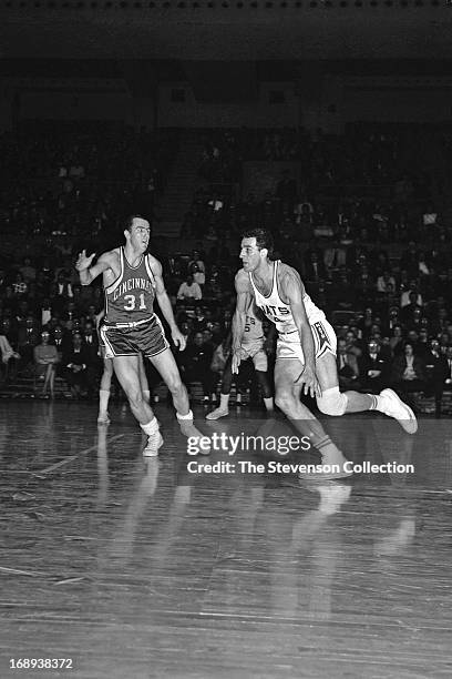 Dolph Schayes of the Syracuse Nationals dribbles the ball against Jack Twyman of the Cincinnati Royals circa 1962 at the Onondaga War Memorial in...
