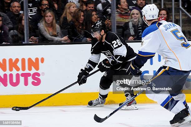 Jarret Stoll of the Los Angeles Kings skates with the puck against Barret Jackman of the St. Louis Blues in Game Six of the Western Conference...