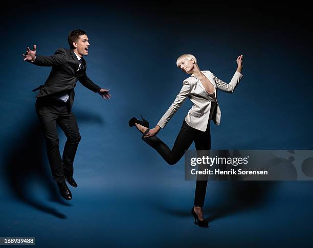 business man and woman jumping - woman in suit stock pictures, royalty-free photos & images