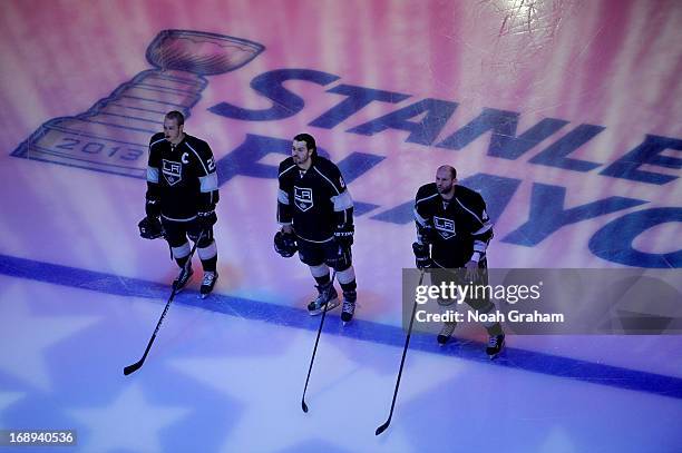 Dustin Brown, Drew Doughty and Robyn Regehr of the Los Angeles Kings stand on the ice prior to the game against the St. Louis Blues in Game Six of...