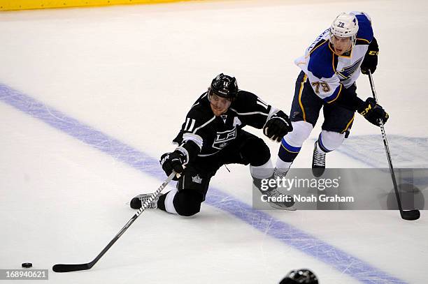 Anze Kopitar of the Los Angeles Kings battles for the puck against Adam Cracknell of the St. Louis Blues in Game Six of the Western Conference...