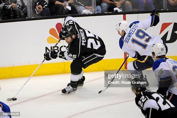 Dustin Penner of the Los Angeles Kings skates with the puck against Jay Bouwmeester of the St. Louis Blues in Game Six of the Western Conference...