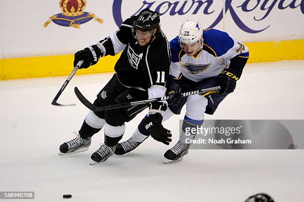 Anze Kopitar of the Los Angeles Kings battles for the puck against Adam Cracknell of the St. Louis Blues in Game Six of the Western Conference...