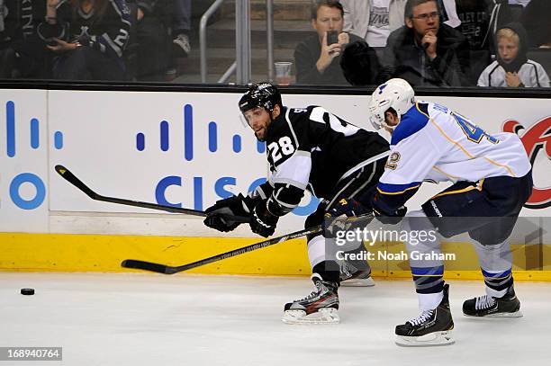 Jarret Stoll of the Los Angeles Kings skates with the puck against David Backes of the St. Louis Blues in Game Six of the Western Conference...