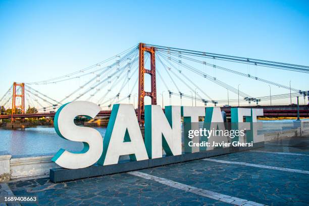 sign with the name of the city and hanging bridge. santa fe, argentina. - santa fe province stock pictures, royalty-free photos & images