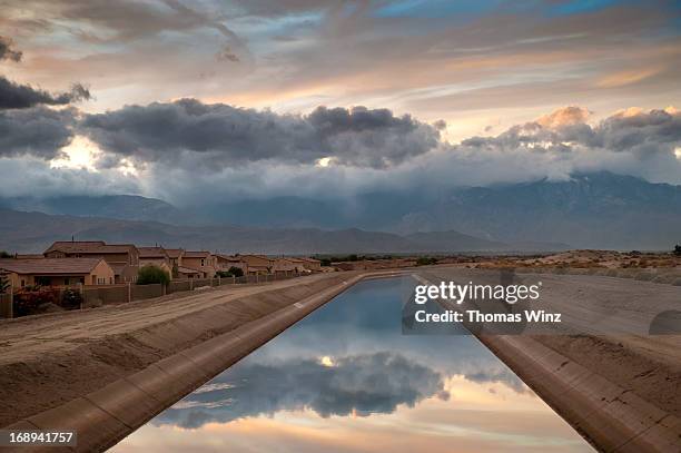 channel along housing development - indio california stock pictures, royalty-free photos & images