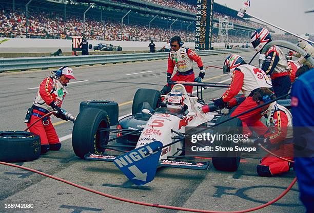 British racing driver Nigel Mansell stops at the pits for fuel and a tyre change during the 77th Indianapolis 500 at the Indianapolis Motor Speedway,...