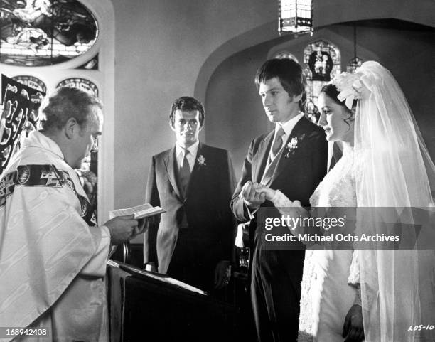 Joseph Hindy watches as Michael Brandon and Bonnie Bedelia are married in a scene from the film 'Lovers And Other Strangers', 1970.